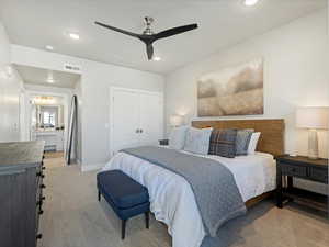 Bedroom featuring recessed lighting, a closet, light carpet, a ceiling fan, and connected bathroom