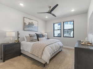 Bedroom featuring light colored carpet, a ceiling fan, and recessed lighting