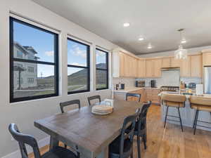 Dining space featuring light wood-style floors, a mountain view, and recessed lighting