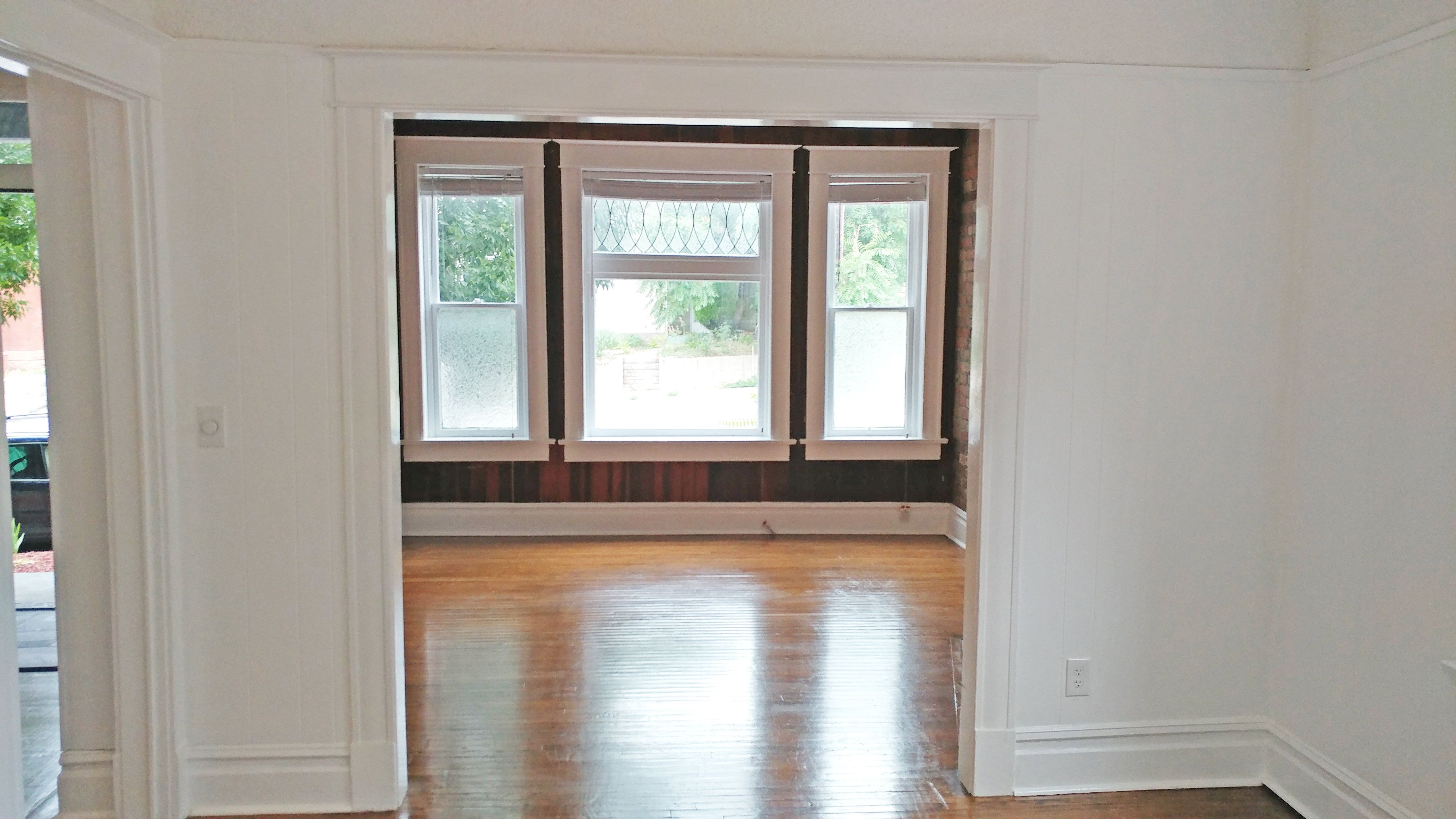 Spare room with wood finished floors and healthy amount of natural light
