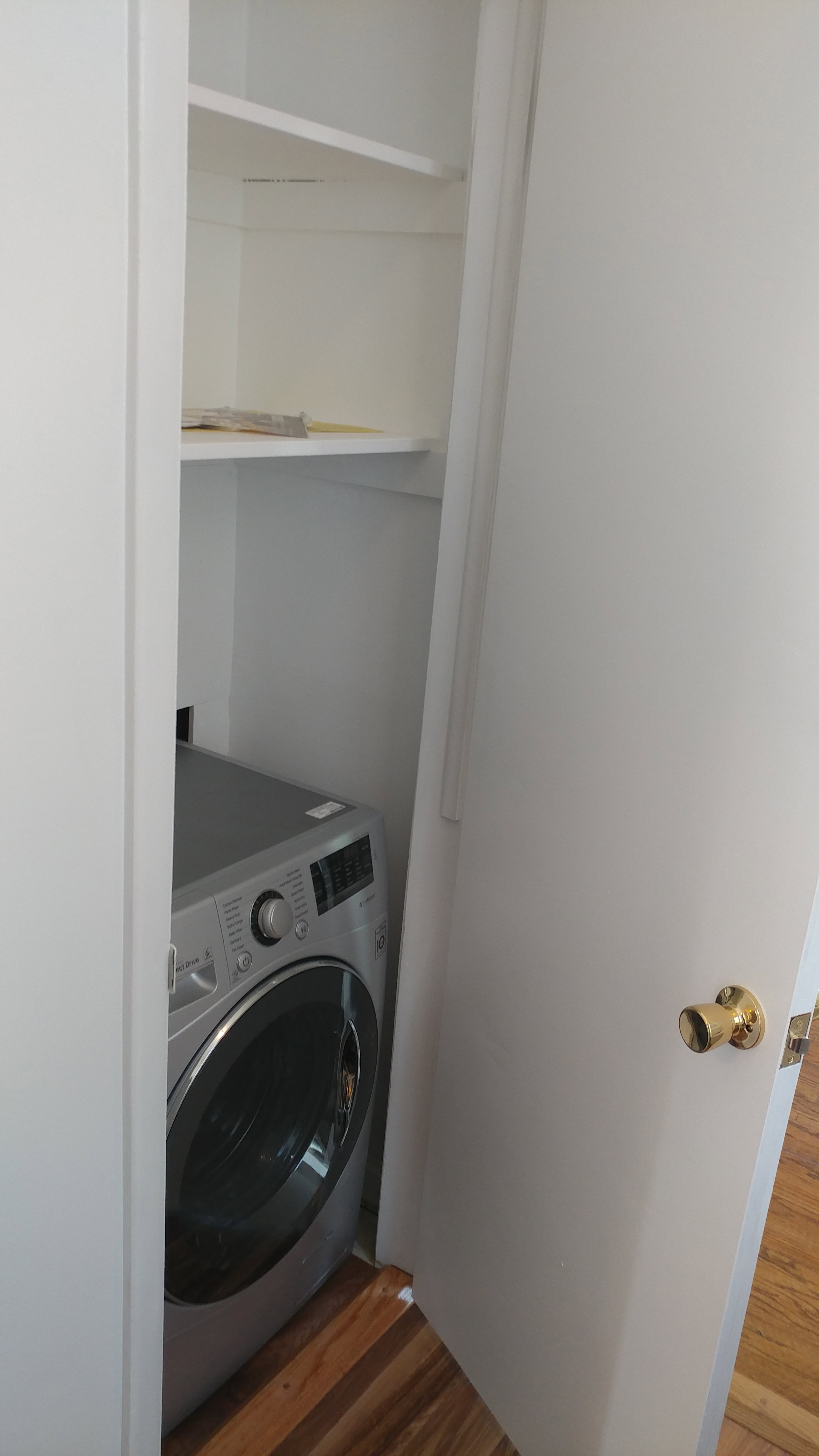 Laundry area featuring washer / dryer and dark wood-type flooring