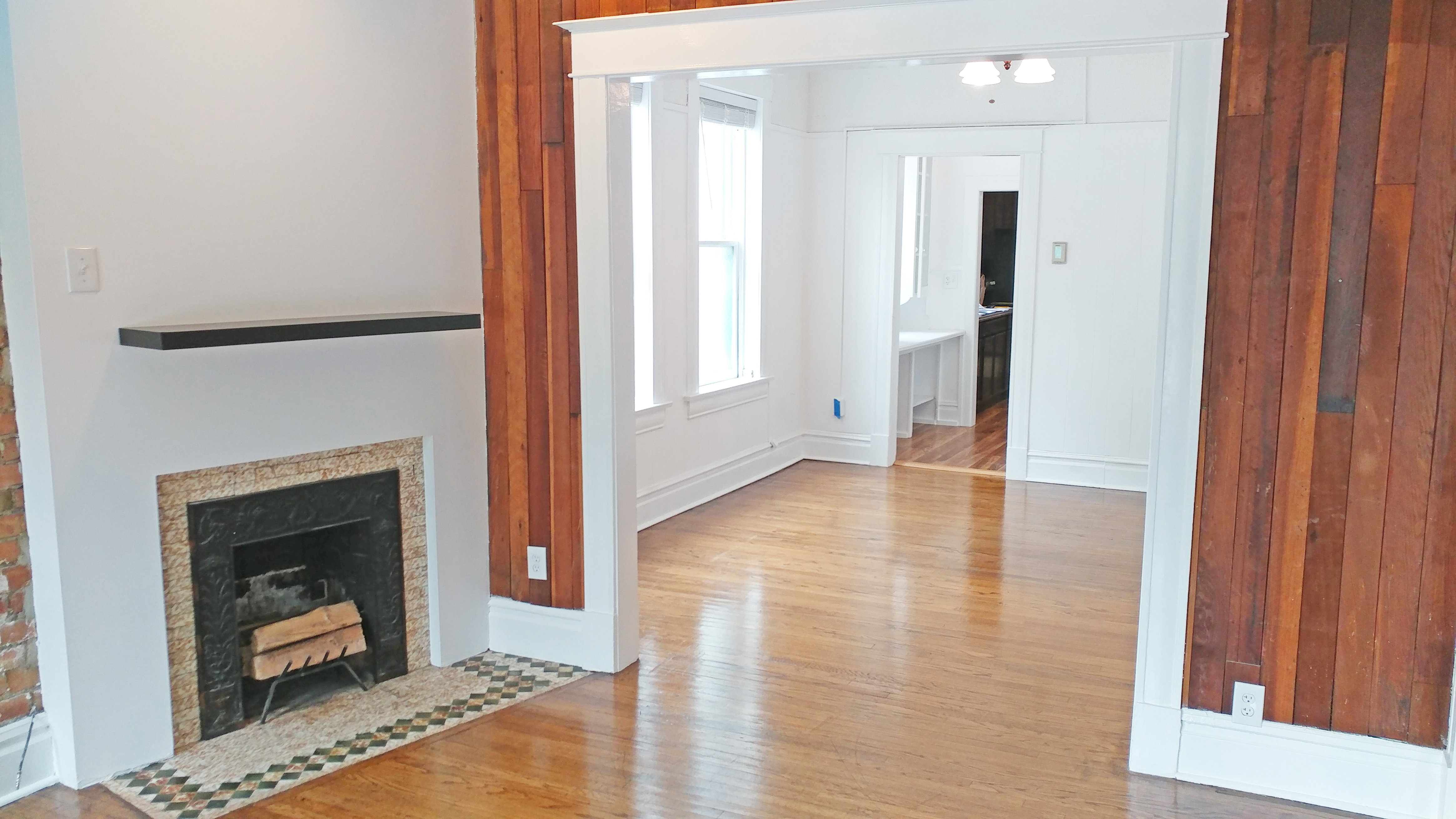 Unfurnished living room featuring light wood-type flooring and a fireplace