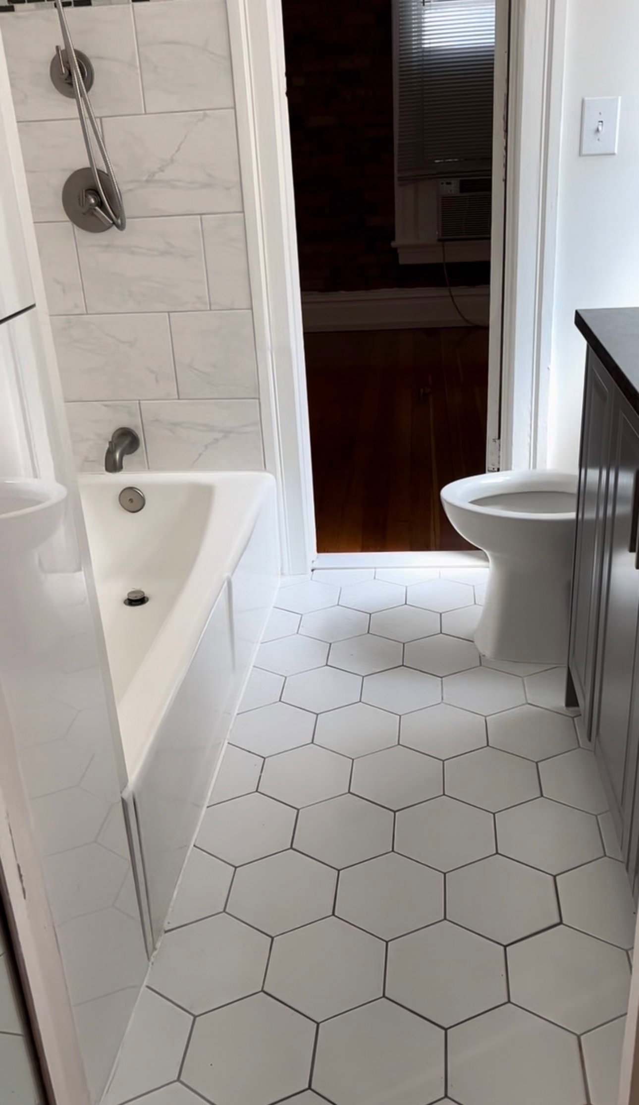 Full bath with vanity, light tile patterned flooring, and shower / tub combination