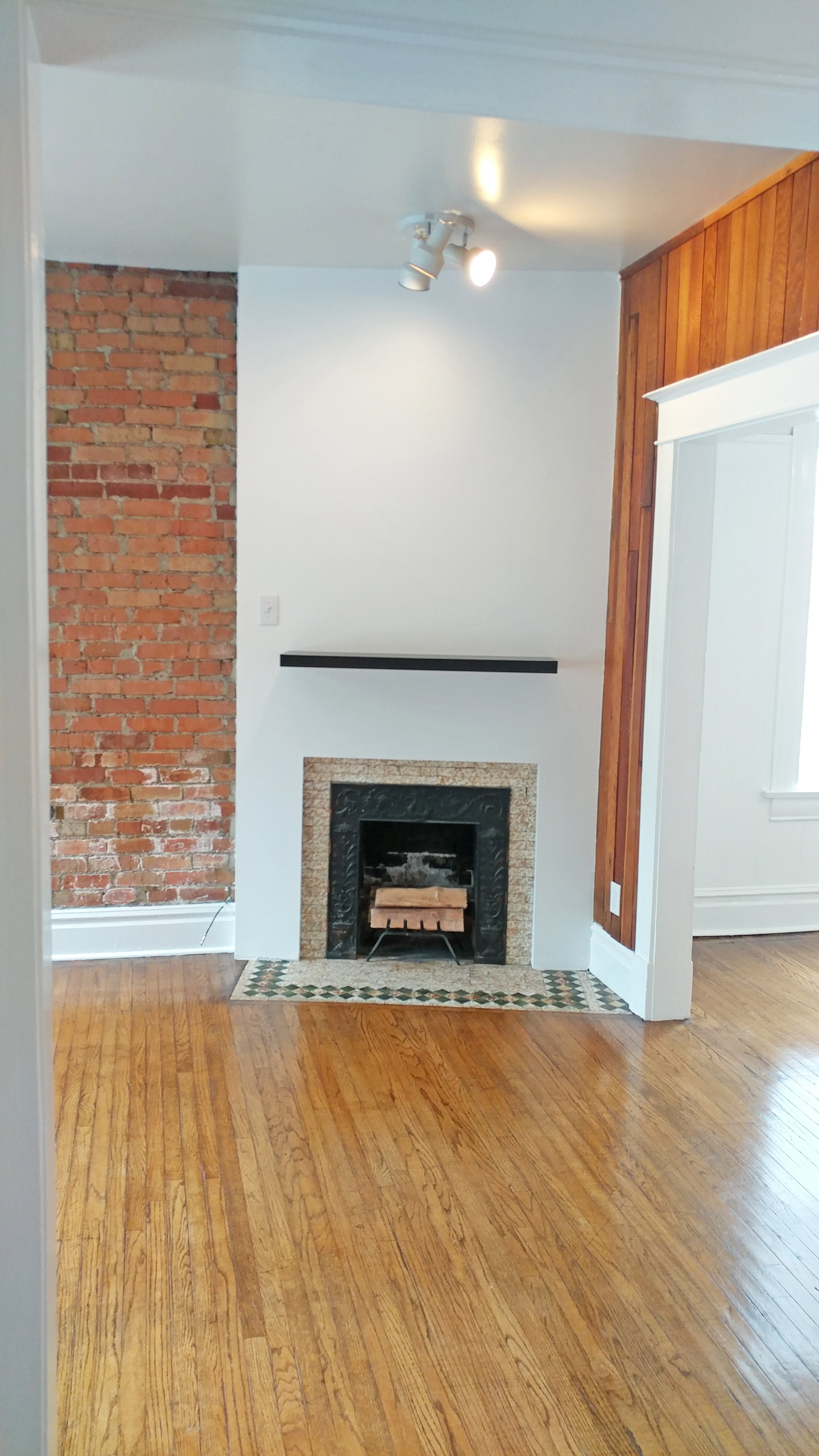 Unfurnished living room featuring light wood-type flooring and a fireplace