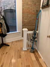 Interior space featuring wood finished floors and brick wall