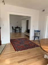 Corridor with light wood-style flooring and baseboards