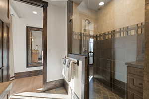 Tree bedroom bathroom with a shower stall, vanity, wood finished floors, and recessed lighting