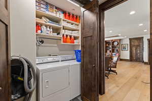 Laundry area with recessed lighting, light wood-style flooring, separate washer and dryer, and an office area