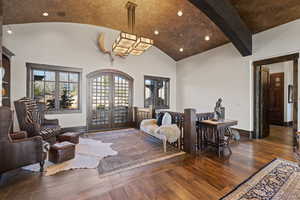 Sitting room with french doors, dark wood-style flooring, recessed lighting, vaulted ceiling, and arched walkways