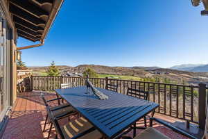 Balcony featuring outdoor dining area and a mountain view