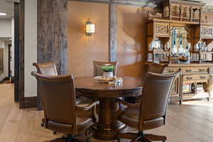Family game room area with light wood-style flooring