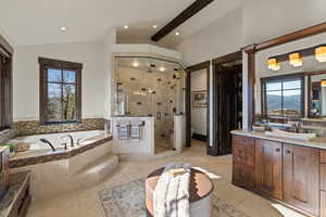 Primary Full bathroom featuring vanity, recessed lighting, a shower stall, lofted ceiling, and a garden tub