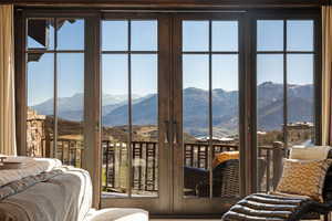 Primary Bedroom with multiple windows, a mountain view, and access to exterior