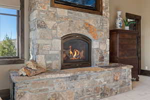 Primary Bedroom Detailed view of a stone fireplace and baseboards