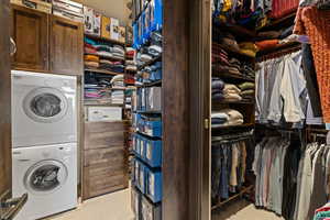 Primary closet with Laundry area with stacked washer / dryer