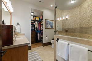 Blue bedroom Bathroom featuring vanity, a shower stall, a spacious closet, recessed lighting, and a textured ceiling