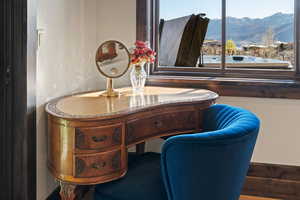 Blue bedroom featuring a mountain view and wood finished floors