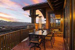 Balcony with outdoor dining space and a mountain view