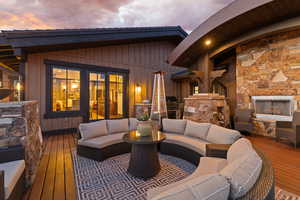 Deck featuring a fireplace and an outdoor kitchen and area to lounge