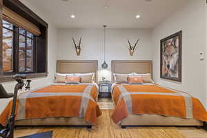 Queen Guest Bedroom with wood finished floors and recessed lighting