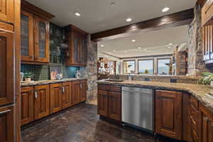 Kitchenette/Bar with dishwasher, glass fronted cabinets, light stone countertops, recessed lighting, and dark wood-type flooring