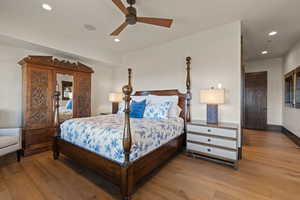 Blue Bedroom with light wood-style floors, a ceiling fan, and recessed lighting
