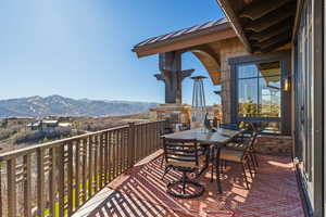 Balcony with a mountain view and outdoor dining area