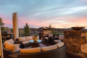 Deck at dusk with a deck with mountain view and outdoor seating