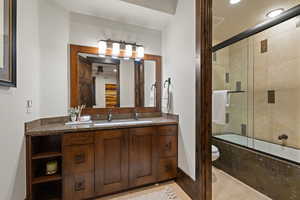 Queen Guest Full bathroom featuring vanity, enclosed tub / shower combo, recessed lighting, and light tile patterned floors