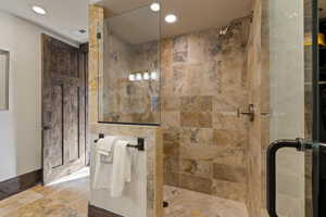 Bear bedroom bathroom with a stall shower and recessed lighting
