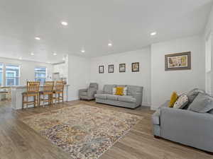 Living area featuring light wood-type flooring and recessed lighting
