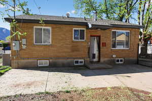 Rear view of property featuring brick siding and a patio area