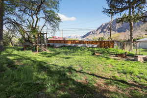 Fenced yard featuring a mountain view