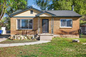 Bungalow-style house with brick siding