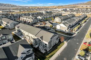 Aerial view of rear of end unit, residential area with a mountain backdrop