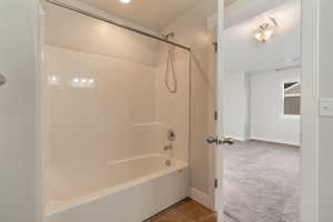 Master bath, shower combination, and light tile patterned floors