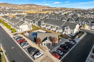 Aerial view of residential area and club house with a mountainous background.
