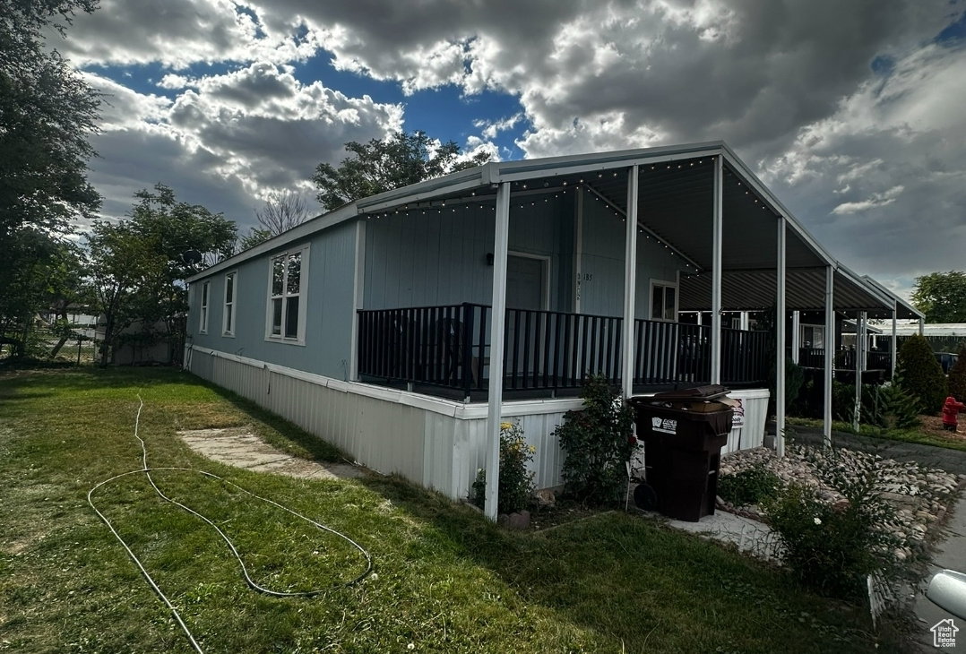View of side of property with a yard