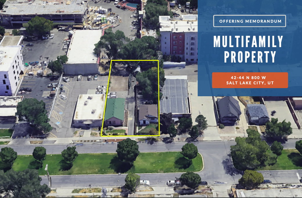 Multifamily property site bordered by a public road and mature trees