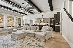 Living area with recessed lighting, light wood-style flooring, ceiling fan, and beamed ceiling