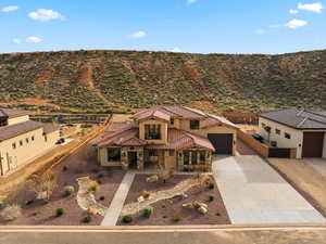 Mediterranean / spanish-style home with concrete driveway, stucco siding, a tile roof, and a garage