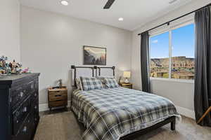 Bedroom with dark carpet, a mountain view, recessed lighting, and ceiling fan