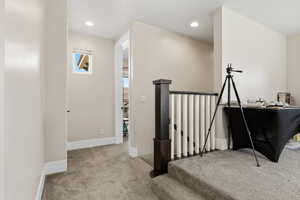 Stairs featuring carpet and recessed lighting