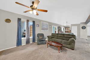 Living room featuring carpet flooring, healthy amount of natural light, and ceiling fan