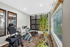 Workout room with wood finished floors, healthy amount of natural light, and recessed lighting