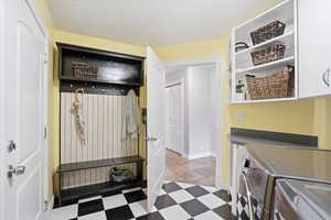Laundry area with cabinet space and washing machine and clothes dryer