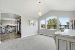 This room features a vaulted ceiling and bright windows which could be used as a formal dining room, music room, office, or formal living room