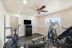 Workout room/bedroom #5 featuring ceiling fan, recessed lighting, and a textured ceiling