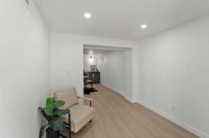 Sitting room featuring light wood finished floors and recessed lighting