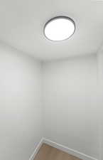 Empty room featuring baseboards and light wood-type flooring